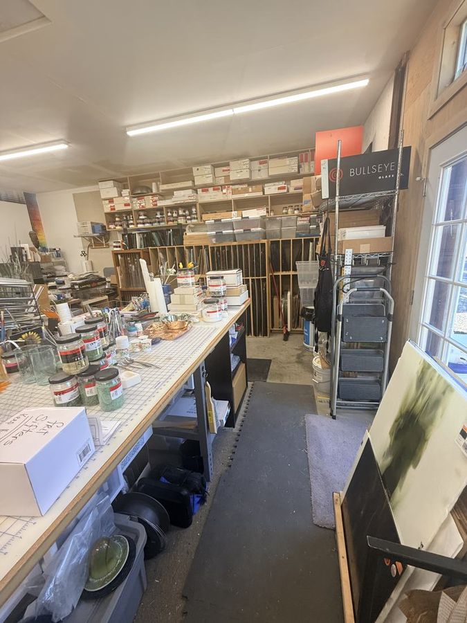 The studio bench and glass shelves